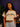 Lady Q’s Corner beige cropped graphic tee with green camo ATLANTA and orange GEORGIA text worn by a woman.
