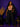 Lady Q’s Corner sleeveless beige V-neck bodysuit worn with black trousers and a blazer by a woman in a studio.