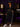 Lady Q’s Corner black athletic track pants with side stripes and zippered hems worn by a woman in a matching set
