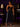 Lady Q’s Corner black athletic track pants with side stripes and zippered hems worn with a lace bodysuit and heels.