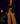 Lady Q’s Corner black double-breasted tailored blazer with gold buttons worn by a woman with brown wide-leg trousers