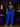 Lady Q’s Corner vibrant electric blue high-waisted cargo pants with side pockets and zippers on a stylish woman.