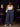 Lady Q’s Corner high-waisted blue wide-leg trousers with elastic waistband and side pockets worn with a white tank top.