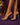 Lady Q’s Corner clear strap stiletto mule sandals with transparent heels worn on a purple background