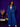 Lady Q’s Corner denim blazer and wide-leg trouser set in classic blue with gold buttons worn by a smiling woman.