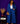 Lady Q’s Corner blue denim double-breasted blazer and wide-leg trouser set worn by a woman with gold accessories.