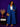 Lady Q’s Corner blue denim double-breasted blazer and wide-leg trouser set worn by a woman with gold accessories.