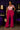 Lady Q’s Corner magenta high-waisted flare trousers with double-button detail worn by a woman with a patterned blouse.