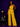 Lady Q’s Corner mustard yellow strapless wide-leg jumpsuit with a tie-waist belt worn by a model in a studio.