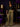 Lady Q’s Corner olive green satin wide-leg trousers with an elasticated waist, styled with a black blazer and handbag.