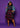 Model wearing a Lady Q’s Corner multi-colored tartan pleated midi skirt with a denim jacket and black heels