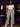 Lady Q’s Corner high-waisted wide-leg plaid trousers in white with red, black, and green tartan, worn with a white top.