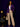 Lady Q’s Corner deep purple pinstripe double-breasted blazer worn by a woman with beige trousers and a handbag