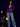 Lady Q’s Corner deep purple pinstripe double-breasted blazer worn with wide-leg jeans and a white shoulder bag.