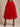 Lady Q’s Corner vibrant red tulle midi skirt with a comfortable elastic waistband worn with black strappy heels.