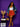 Lady Q’s Corner rust-orange pleated mini skirt worn by a smiling woman with a denim blazer and gold accessories.